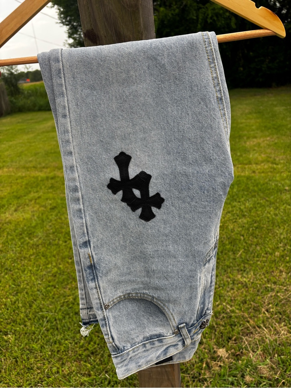 Chrome Hearts Light Wash Jeans with Black Cross Patch